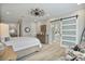 Spacious bedroom with wood floors, and sliding door to bathroom at 8154 E Jaeger St, Mesa, AZ 85207