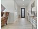 Inviting foyer featuring light wood flooring, neutral paint, decorative console table, and an attractive iron-accented door at 8154 E Jaeger St, Mesa, AZ 85207