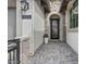 View of the home's front entrance with pavers, stone accents, welcome sign, and an ornate decorative security door at 8154 E Jaeger St, Mesa, AZ 85207