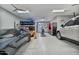 Large garage featuring car lift, multiple vehicles, work bench, and well-lit space at 8154 E Jaeger St, Mesa, AZ 85207