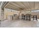 Inviting covered outdoor kitchen with stone accents, bar seating, and stainless steel gas grill at 8154 E Jaeger St, Mesa, AZ 85207