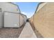 Side yard with a long stone path leading to the back, featuring a storage shed at 8154 E Jaeger St, Mesa, AZ 85207