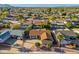 Aerial view of a single-Gathering home with a brown roof, mature trees, and a swimming pool at 8656 E Plaza Ave, Scottsdale, AZ 85250
