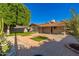 Backyard showcasing meticulous landscaping, turf, mature trees, and a patio at 8656 E Plaza Ave, Scottsdale, AZ 85250