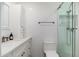 Bright bathroom featuring a walk-in shower with a glass door, white tile, and modern fixtures at 8656 E Plaza Ave, Scottsdale, AZ 85250