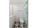 Stylish bathroom with a glass shower and creative tile flooring at 8656 E Plaza Ave, Scottsdale, AZ 85250