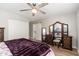 Spacious bedroom featuring a statement vanity, a decorative ceiling fan, and wood flooring at 8656 E Plaza Ave, Scottsdale, AZ 85250