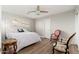 Comfortable bedroom with a ceiling fan, hardwood floors, and natural light creating a relaxing atmosphere at 8656 E Plaza Ave, Scottsdale, AZ 85250