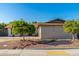 Lovely home exterior featuring desert landscaping and mature shade trees at 8656 E Plaza Ave, Scottsdale, AZ 85250