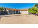 Charming single-story home with a well-maintained front yard and a spacious driveway at 8656 E Plaza Ave, Scottsdale, AZ 85250