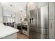 Modern kitchen featuring stainless steel appliances and a view into the open concept living area at 8656 E Plaza Ave, Scottsdale, AZ 85250