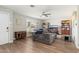 Comfortable living room with wood floors, ceiling fan, and plantation shutters at 8656 E Plaza Ave, Scottsdale, AZ 85250