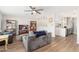 Inviting living room with wood floors, a ceiling fan, and an open kitchen view at 8656 E Plaza Ave, Scottsdale, AZ 85250