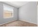 Relaxing bedroom features a window, neutral walls, and comfortable carpeting at 9431 E Coralbell Ave # 178, Mesa, AZ 85208