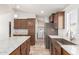 Spacious kitchen featuring stainless steel appliances and an adjacent laundry room at 9431 E Coralbell Ave # 178, Mesa, AZ 85208