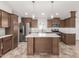 Well-appointed kitchen boasts an island, stainless appliances, and ample counter space at 9431 E Coralbell Ave # 178, Mesa, AZ 85208