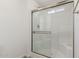 Shower with glass doors, a built-in seat, and modern fixtures at 9431 E Coralbell Ave # 178, Mesa, AZ 85208