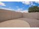Spacious backyard with a patio area surrounded by a tall privacy wall with blue skies above at 10001 W Potter Dr, Peoria, AZ 85382