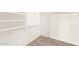Walk in closet featuring carpeted floor and built in white shelving at 10001 W Potter Dr, Peoria, AZ 85382