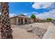 Charming single-story home featuring a desert landscape, covered porch, and attached two-car garage at 10001 W Potter Dr, Peoria, AZ 85382
