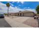 Charming single-story home featuring a desert landscape, covered porch, and attached two-car garage at 10001 W Potter Dr, Peoria, AZ 85382