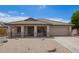 Charming single-story home featuring a desert landscape, covered porch, and attached two-car garage at 10001 W Potter Dr, Peoria, AZ 85382