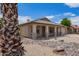 Charming single-story home featuring a desert landscape, covered porch, and attached two-car garage at 10001 W Potter Dr, Peoria, AZ 85382