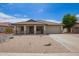 Charming single-story home featuring a desert landscape, covered porch, and attached two-car garage at 10001 W Potter Dr, Peoria, AZ 85382