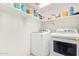 Bright laundry room with white cabinets and modern washer and dryer at 10001 W Potter Dr, Peoria, AZ 85382