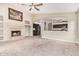 Spacious living room featuring a fireplace, arched entryways, and views into the kitchen at 10001 W Potter Dr, Peoria, AZ 85382
