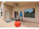 Covered patio features a ceiling fan, sliding glass door, and outdoor seating area at 10001 W Potter Dr, Peoria, AZ 85382