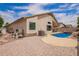 Backyard with a sparkling blue pool, rock features and a spacious patio area at 10001 W Potter Dr, Peoria, AZ 85382
