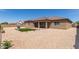 Expansive backyard with desert landscaping and a cozy covered patio, great for outdoor relaxation at 19011 E Carriage Way, Queen Creek, AZ 85142