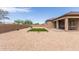 An outdoor oasis with a built-in grill, grassy patch, and covered patio presents an entertainer's dream at 19011 E Carriage Way, Queen Creek, AZ 85142
