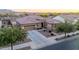 A well-manicured front yard complements this single-Gathering home with a three car garage and desert landscaping at 19011 E Carriage Way, Queen Creek, AZ 85142