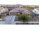 Charming single-story home with a well-manicured front yard and a spacious driveway at 19011 E Carriage Way, Queen Creek, AZ 85142