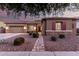 Charming single-story home with stone accents, desert landscaping, and a striking red front door at 19011 E Carriage Way, Queen Creek, AZ 85142
