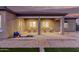 A covered patio with brick pavers provides a cozy outdoor seating area with four chairs and an outdoor toy at 19011 E Carriage Way, Queen Creek, AZ 85142