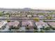 An eye-level shot of the property featuring the house and surrounding neighborhood at 19011 E Carriage Way, Queen Creek, AZ 85142
