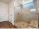Modern bathroom featuring a glass shower with a built-in bench and wood-look tile surround at 21277 N 272Nd Ave, Buckeye, AZ 85396
