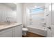 A well-lit bathroom has a shower/tub combination, a vanity with stone countertops, and wood look tile floors at 21277 N 272Nd Ave, Buckeye, AZ 85396