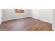 Bedroom with wood-look tile flooring, white walls, baseboards, and natural light at 21277 N 272Nd Ave, Buckeye, AZ 85396