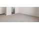 Bright, empty bedroom with neutral carpet and a doorway to the bathroom at 21277 N 272Nd Ave, Buckeye, AZ 85396