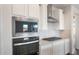 Built-in stainless steel oven and microwave above a gas cooktop in a modern kitchen at 21277 N 272Nd Ave, Buckeye, AZ 85396