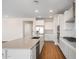 Well-lit kitchen showcases a large island, modern appliances, and sleek white cabinetry at 21277 N 272Nd Ave, Buckeye, AZ 85396