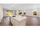 Spacious living area features an island, recessed lighting, and wood-look floors at 21277 N 272Nd Ave, Buckeye, AZ 85396