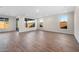 Spacious open-concept room with tile flooring, white walls, and multiple windows offering ample natural light at 21277 N 272Nd Ave, Buckeye, AZ 85396