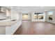 A bright open-concept living space has wood-look tile floors and several large windows at 21277 N 272Nd Ave, Buckeye, AZ 85396