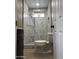 Modern bathroom with marble tile, window, and updated fixtures at 4418 N 34Th Dr, Phoenix, AZ 85017