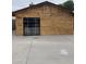 Charming barn-like exterior with wood siding and a black-framed glass door at 4418 N 34Th Dr, Phoenix, AZ 85017